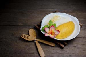 Ripe Mango with sticky rice on wood background,still life photo