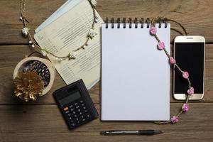 notebook with smartphone and account book on wood background,Business concept photo