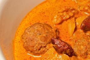 Thai yellow Massaman curry with minced meatball and almonds photo