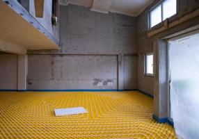 yellow underfloor heating installation with white pipes photo