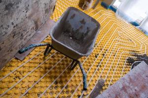 yellow underfloor heating installation with white pipes photo