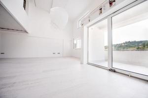 Interior of empty stylish modern open space two level apartment photo