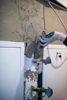 Worker plastering the wall by concrete photo