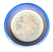 Surface of bubbles or lathers cover dirty water. in blue container isolated. photo