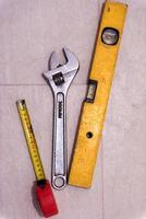 set of hand working tools on ceramic tile background photo