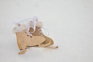 Wooden Christmas decoration skates lie in the snow. photo