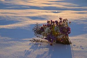 The bouqet of pink birthday flowers on the snow garden in the country photo