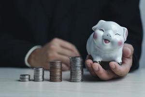 Businessman holding piggy bank.Business finance investment stock tax and insurance saving concept. photo