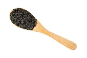 Hairy basil seeds in wooden spoon isolated on white background photo