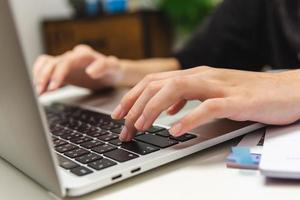 Woman hand using keyboard computer laptop internet communication social network digital technology. photo