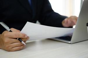 businessman holding documents charts statistical data investment analysis and tax accounting. photo