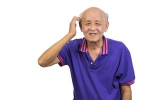 Asian elderly man standing with hands on his head white background. photo