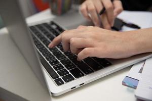 Woman hand using keyboard computer laptop internet communication social network digital technology. photo