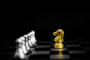 juego de ajedrez oro y plata sobre fondo negro. foto