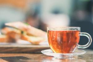 cup of tea at a cafe blurred background and garlic bread. photo