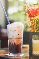 Iced chocolate milkshake drink with cafe blurred background