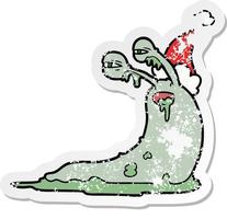 gross distressed sticker cartoon of a slug wearing santa hat vector