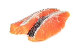 Piece of fresh salmon fillet sliced isolated on white background photo