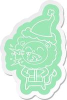 cartoon  sticker of a roaring lion with gift wearing santa hat vector
