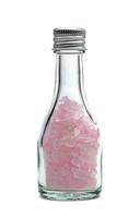 pink rock sugar or crystalline sugar glass bottle isolated on white background photo