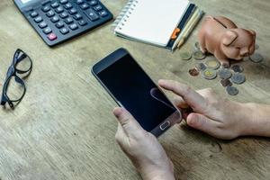 Woman using mobile smart phone on desktop photo