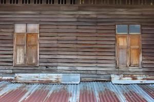 Brown wooden window with zinc roof photo