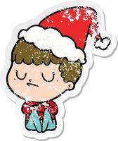 distressed sticker cartoon of a grumpy boy wearing santa hat vector