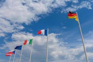 Various flags waving in the wind photo