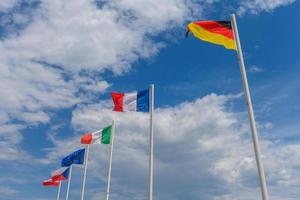 Various flags waving in the wind photo