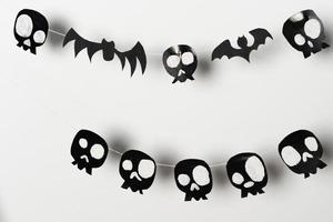 Bats and skulls black on white background, place to write greeting. photo