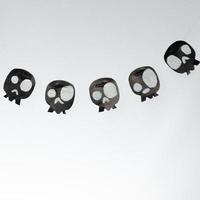 Skulls cut out of black paper on a white background, preparation for Halloween. photo