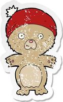 retro distressed sticker of a cartoon cute teddy bear in hat vector