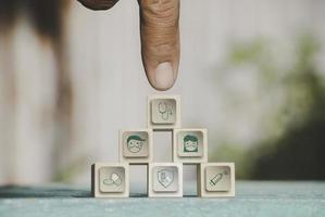 Hand chooses icons healthcare medical symbol on wooden block. vaccine, rising growth.COVID-19. Photo Medical and technology concept.