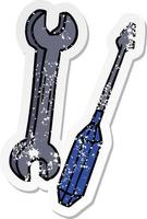 distressed sticker cartoon doodle of a spanner and a screwdriver vector