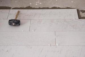 Ceramic wood effect tiles and tools for tiler on the floor photo