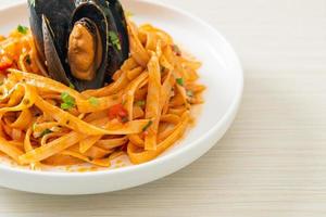 Spaghetti pasta with mussels or clams and tomato sauce photo