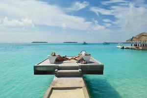 happy young couple have fun on beach photo