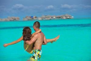 happy young  couple enjoying summer on beach photo