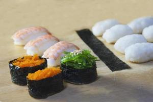 japanese maki sushi roll serving in oriental restaurant, chef is preparing japan tradition cookery menu, various different assorted luxury mixed healthy eating set concept photo