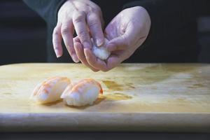 japanese maki sushi roll serving in oriental restaurant, chef is preparing japan tradition cookery menu, various different assorted luxury mixed healthy eating set concept photo