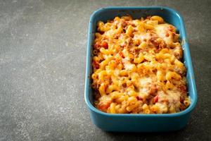 homemade macaroni bolognese with cheese photo