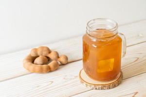Delicious sweet drink tamarind juice and ice cube photo