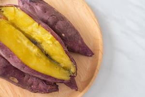 Grilled or baked Japanese sweet potatoes on wood plate photo