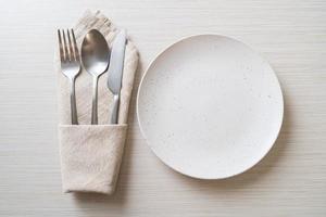 empty plate or dish with knife, fork and spoon photo