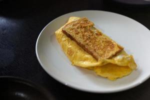Sandwiches with egg, ham and toast cheese fried in white dish photo