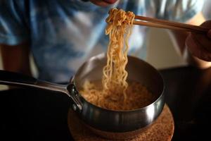 Eating Instant noodles in aluminum pot photo