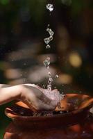 splashing fresh water on woman hands photo