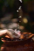 splashing fresh water on woman hands photo