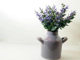 Picture of artificial plastic flower on a ceramic vase photo