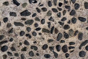 The arrangement of gravel mixed with cement used for pavement corridors in the garden, creates the impression of returning to nature, for a background with a nature theme photo